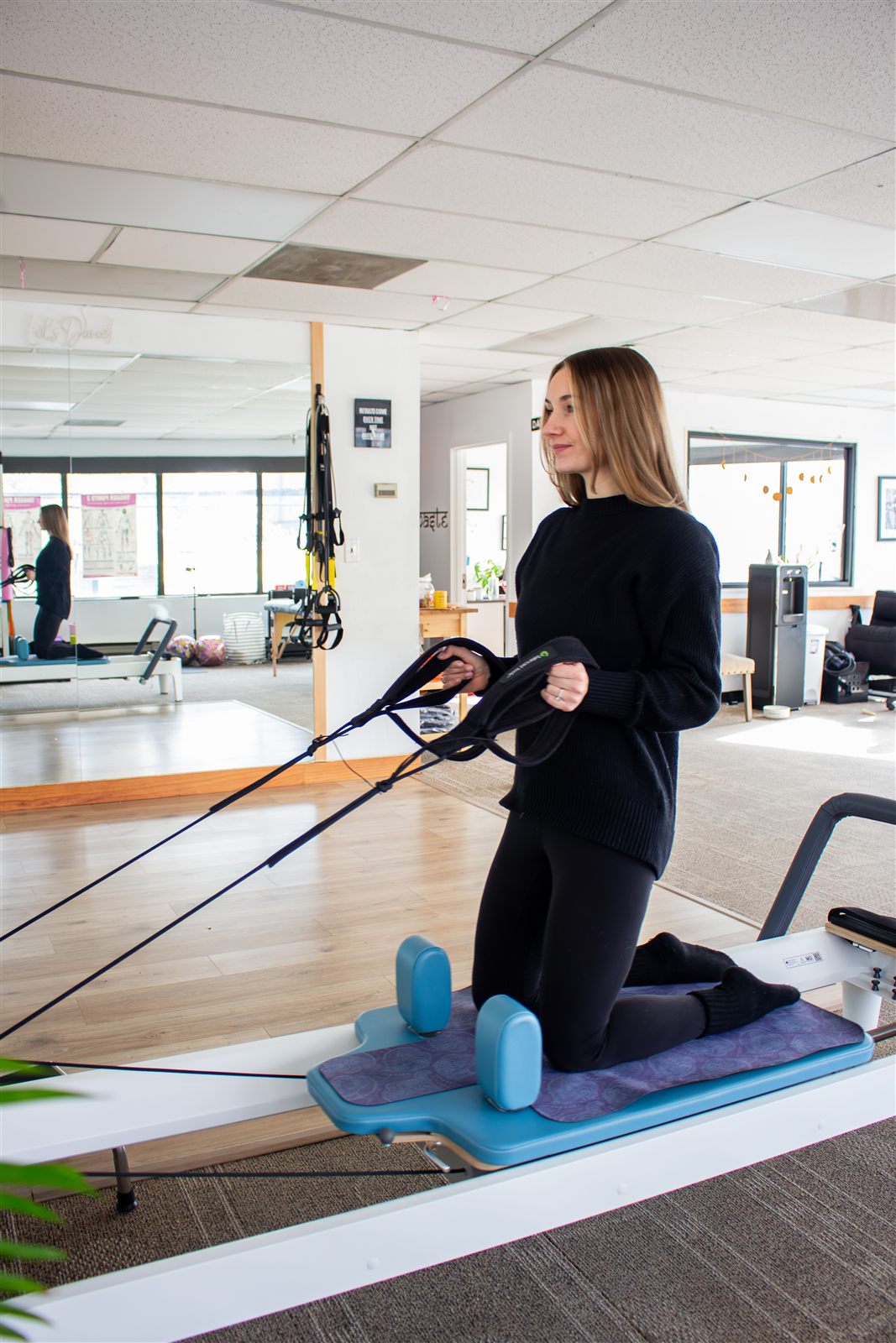 Dr. Lauren Coar demonstrating a Reformer Pilates exercise
