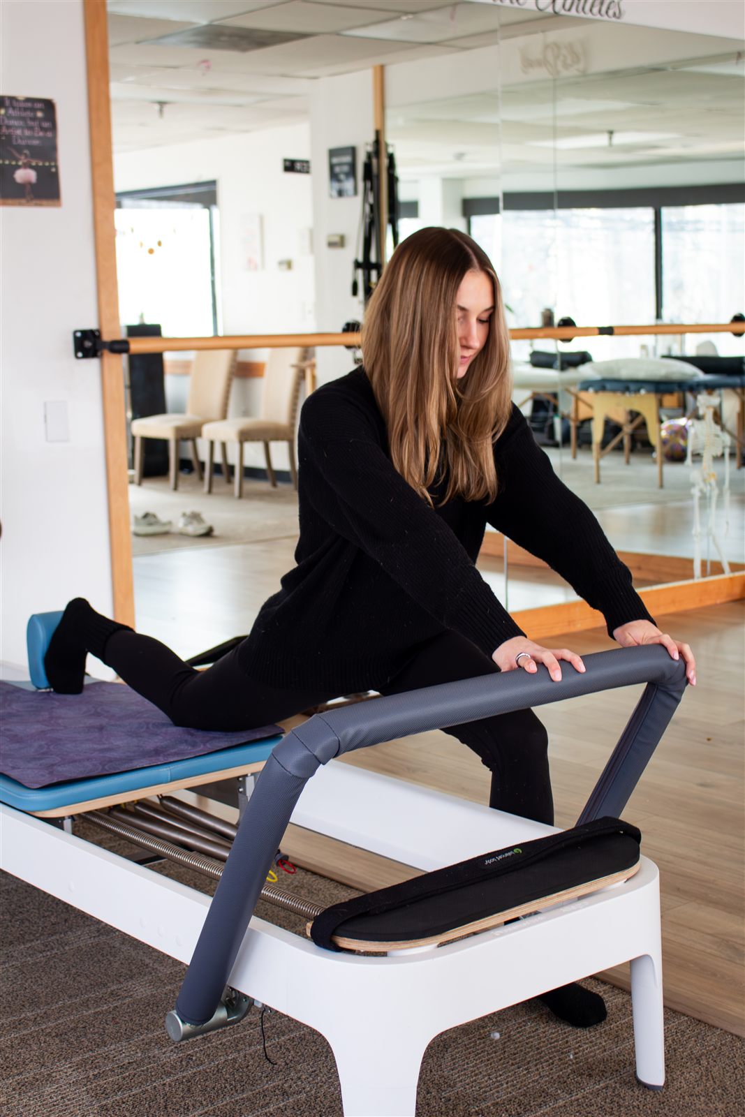 Dr. Lauren Coar demonstrating a Reformer Pilates exercise, second angle