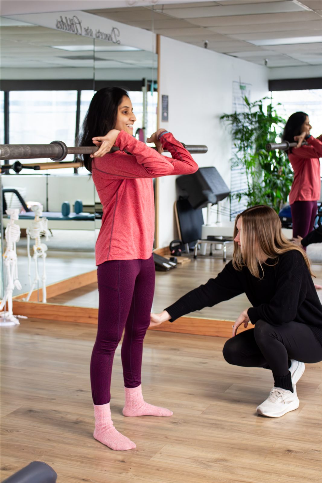 Therapist coaching a patient through a squat